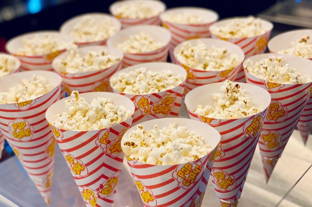 An image of popcorn in white-and-red-striped cones