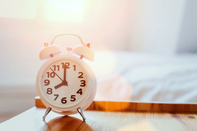 An alarm clock on a wooden surface