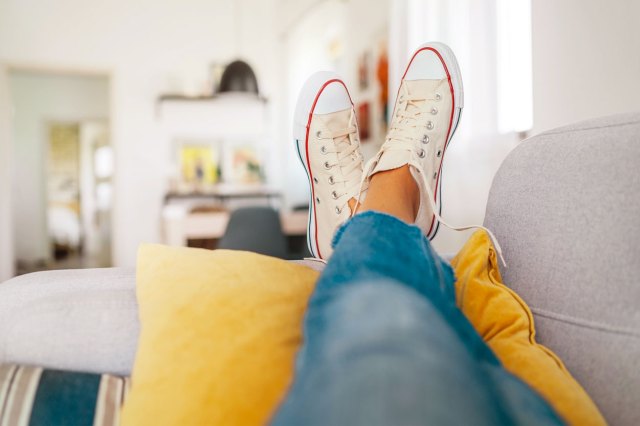 An image of legs resting on a couch