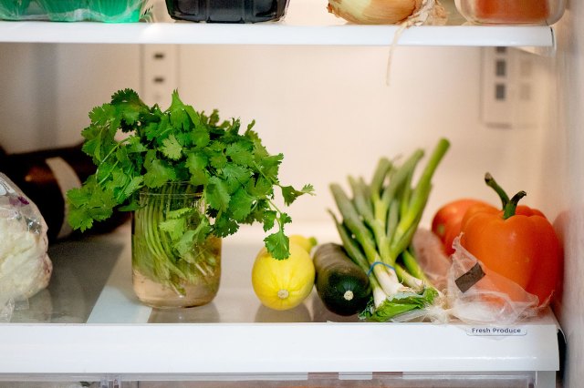An image of herbs and vegetables in the refridgerator