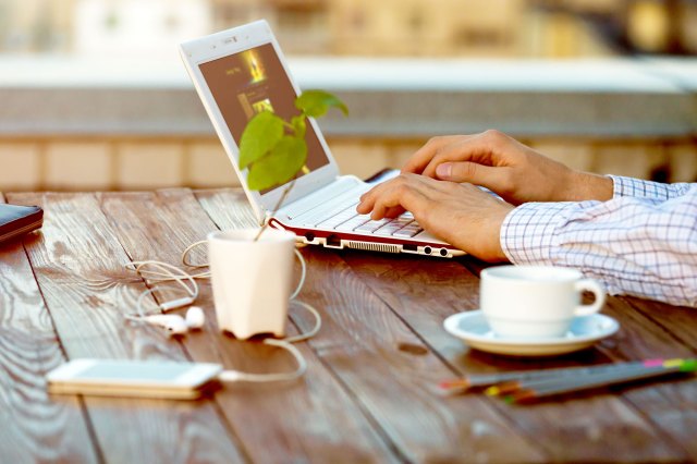 An image of a person typing on a laptop