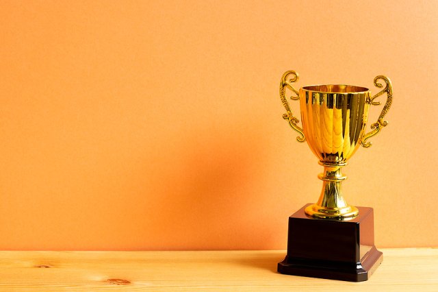 An image of a trophy against a golden background