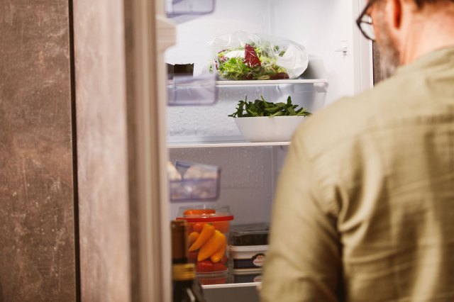 A man looks into the refrigerator