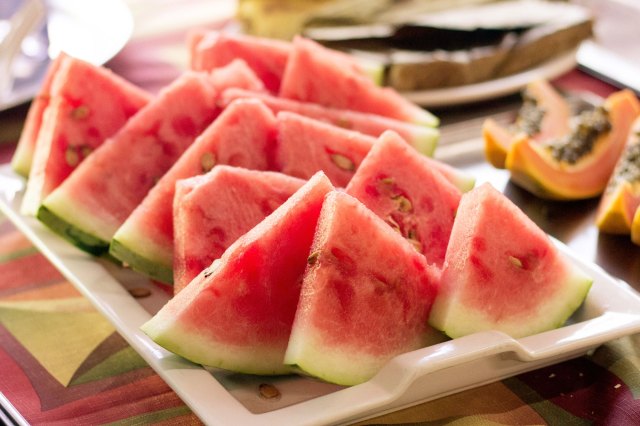 An image of slices of watermelon on a white platter