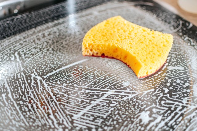 An image of a sponge on top of a soapy surface