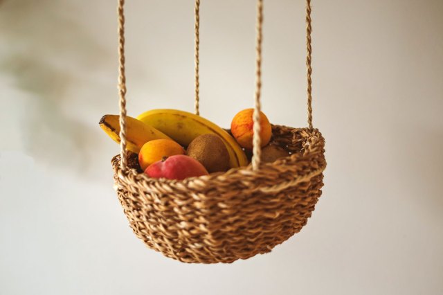 An image of various fruit hanging in a basket