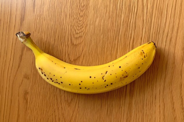 An image of a banana on a wooden table