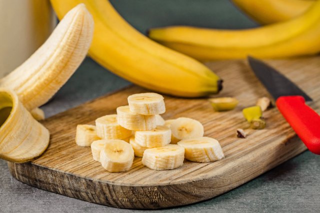An image of sliced bananas on a cutting board
