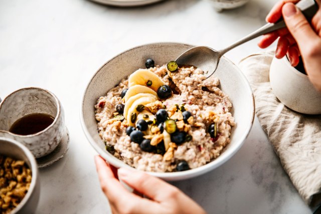 An image of a bowl of oatmeal with berries and bananas