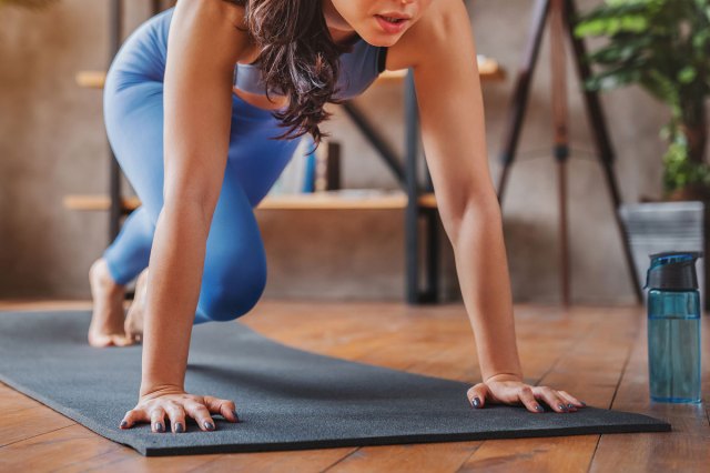 An image of a woman doing a mountain climber