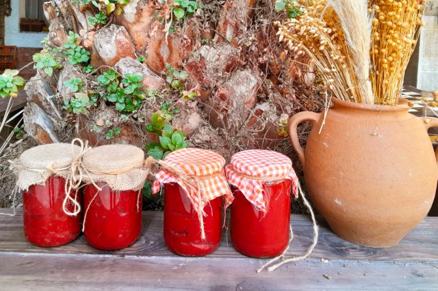An image of jars of tomato sauce outside