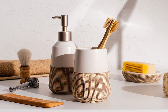 An image of a toothbrush holder and soap dispenser on a bathroom counter