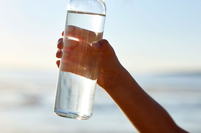 An image of a person holding a bottle of water