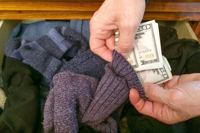 An image of a person storing cash in a sock