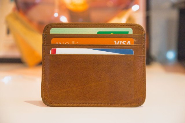 An image of a brown leather wallet with credit cards in it