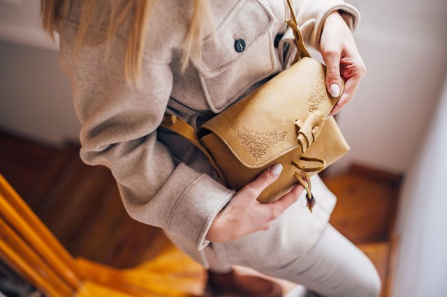 An image of a woman holding a purse