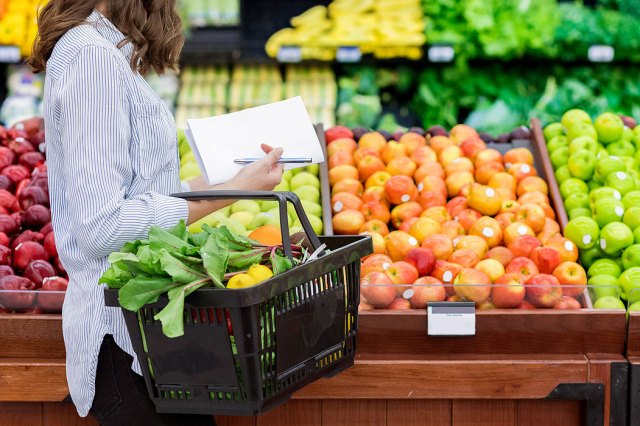 An image of a woman shopping in the produce aisle