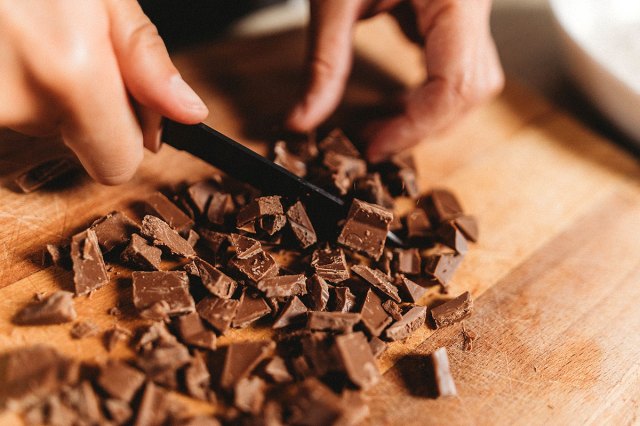 An image of a person chopping chocolate