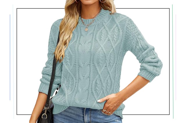 An image of a woman in a light blue cable knit sweater