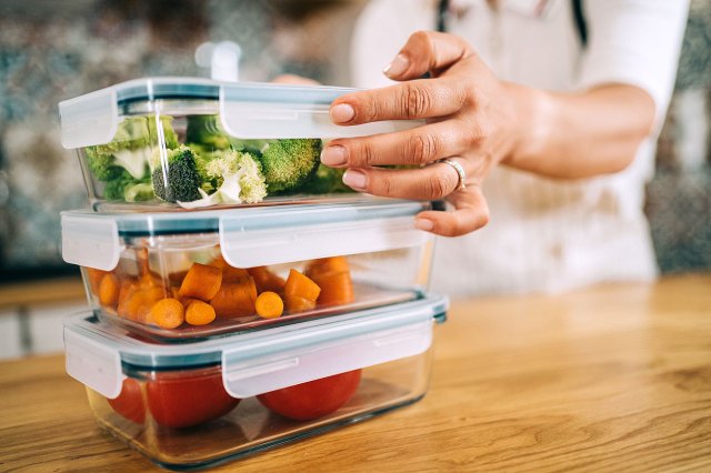 An image of three staked containers with vegetables in them