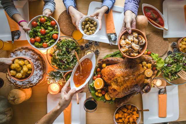 An aerial view of a Thanksgiving table with a turkey and various side dishes