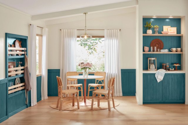 An image of a circular table with chairs and build-in shelves painted in Bay Blue by Minwax