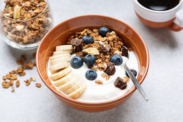An image of a bowl of yogurt with granola and fruit
