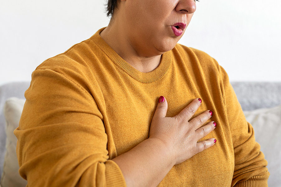 An image of a woman with her hand on her chest