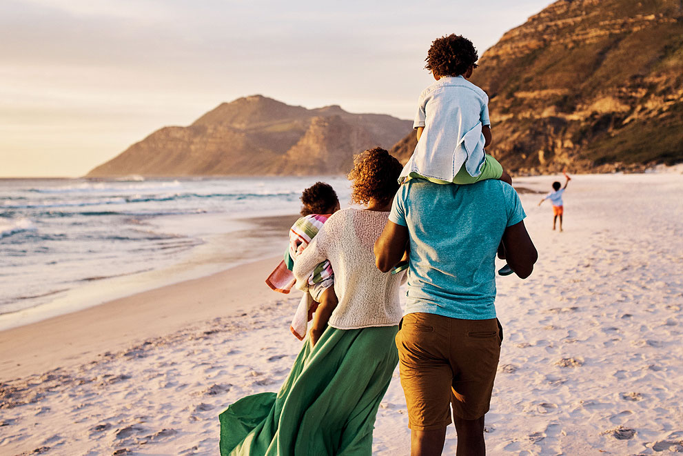 An image of a family walking on the beach