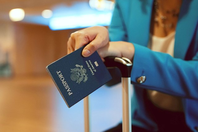 An image of a woman holding a passport