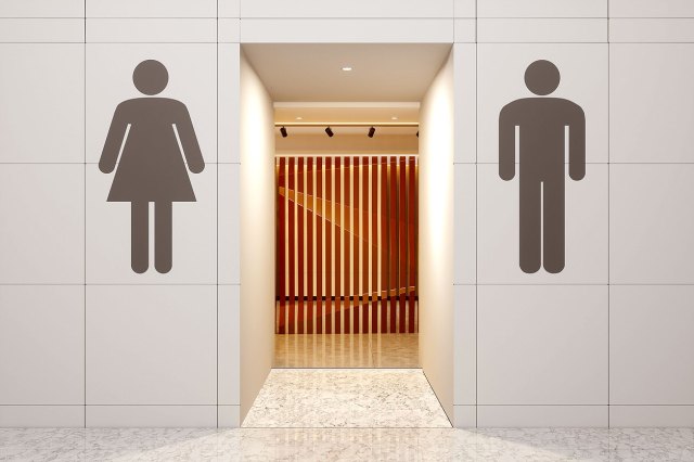 An image of the outside of a public bathroom with the silhouettes of a woman and man on the wall