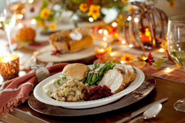 An image of a plate fulled with Thanksgiving food on a table