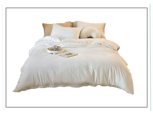An image of a bed with white bedding