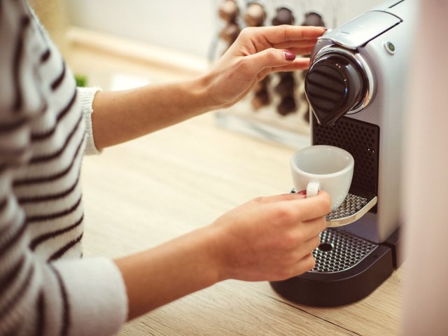 An image of a woman making an espresso