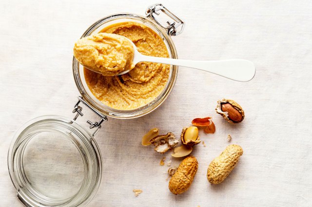 An image of a jar of nut butter with a spoon