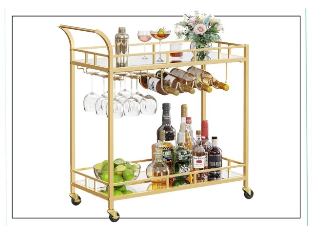 An image of a gold bar cart with glasses, wine bottles, and liquor bottles