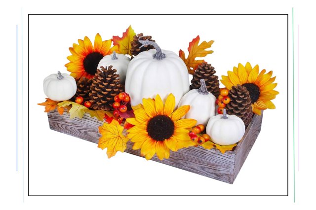An image of a wooden box filled with pumpkins, sunflowers, acorns, and leaves