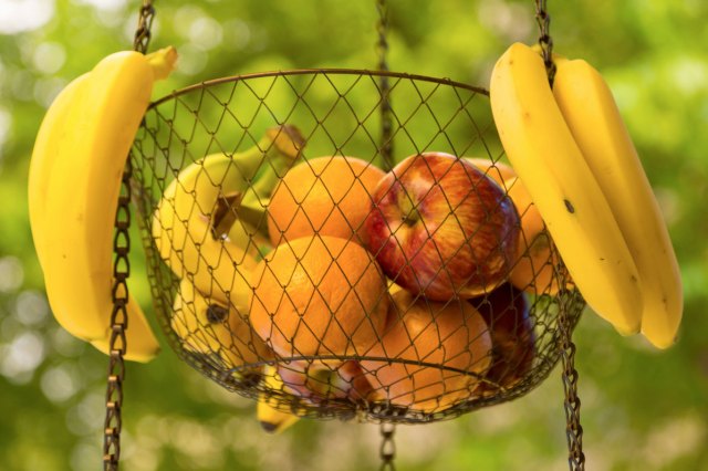 An image of fruit in a hanging basket