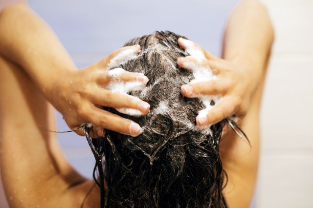An image of a woman washing her hair