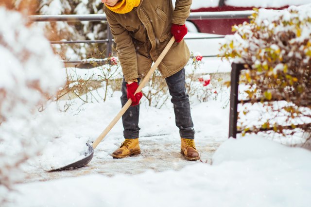 An image of a person shoveling snow
