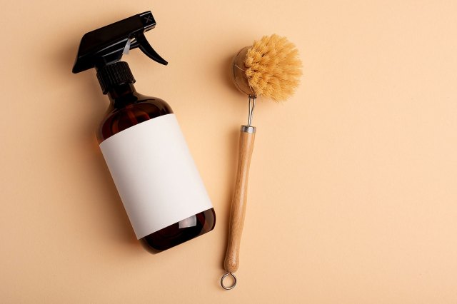 An image of a spray bottle and a scrub brush