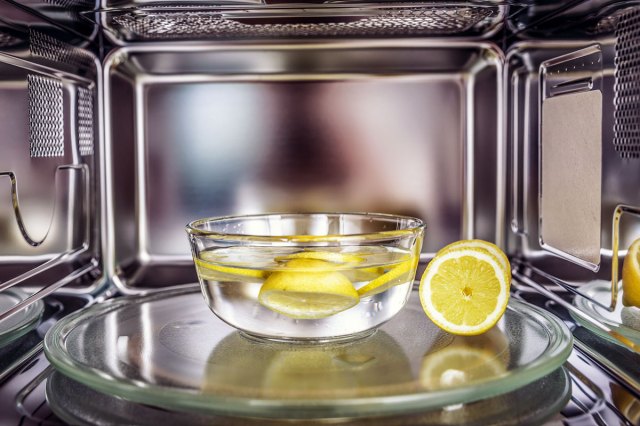 An image of a bowl of water and lemons inside a microwave