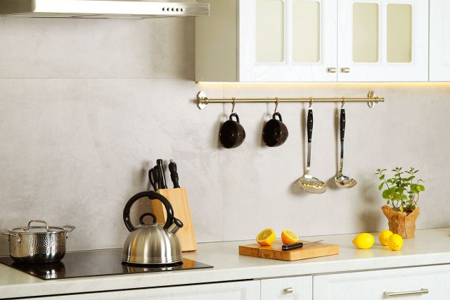 An image of a stylish kettle with whistle on cooktop in kitchen