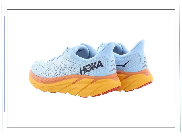 An image of blue sneakers with orange soles