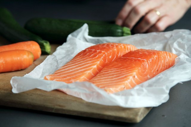 An image of two pieces of salmon on parchment paper