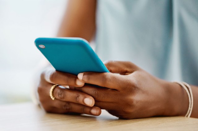 An image of a woman holding a blue cellphone