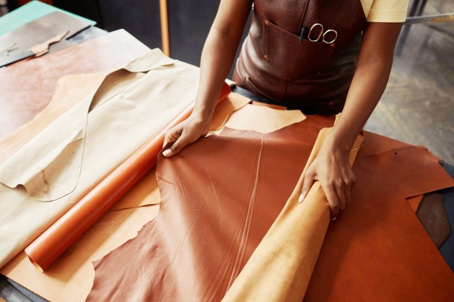 An image of a person rolling out fabric on a table
