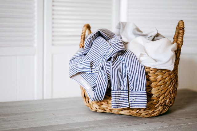 An image of a wicker basket with clothes in it