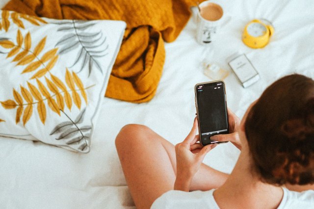 An image of a person holding black iPhone