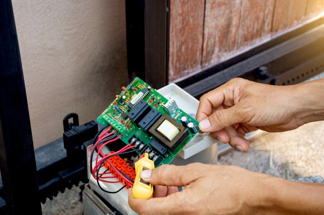 An image of a person testing an electrical panel
